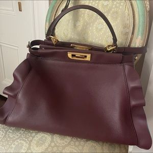 Burgundy Fendi Peekaboo  Wave (medium) purse with strap. Pristine condition.